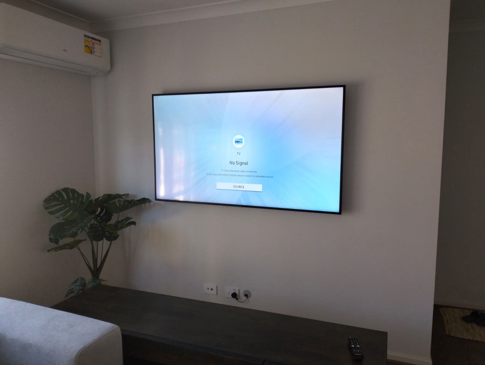 Smart TV mounted on wall with Wi-Fi setup in a minimalist home interior